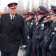 Toronto police chief Bill Blair walks by officers lining the roadway at the public memorial for a police constable on December 9, 2013.